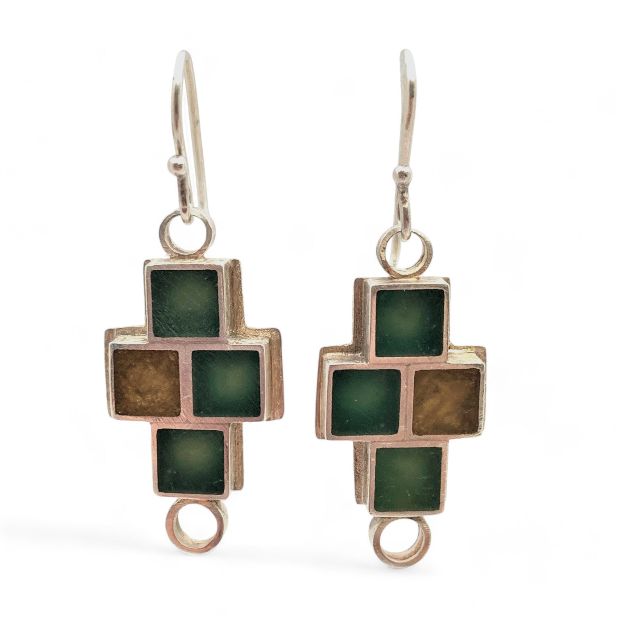 A pair of square-shaped earrings with green and brown tones, crafted from sterling silver and cast resin, featuring a cross-over design.