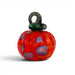 A handcrafted glass pumpkin with a vibrant red and orange marbled body, purple and blue inclusions, and a dark green to black twisted stem.