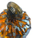 A close-up of a handcrafted glass pumpkin with a ribbed amber-orange body, dark gray smoky glass detailing, and a matching dark gray stem. 