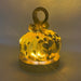 A handcrafted glass pumpkin with a looped stem, illuminated from within by an LED display light with a round wooden base to cast a warm golden glow. 