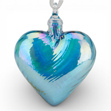 Heart-shaped hand-blown glass ornament with a blue and green iridescent finish 