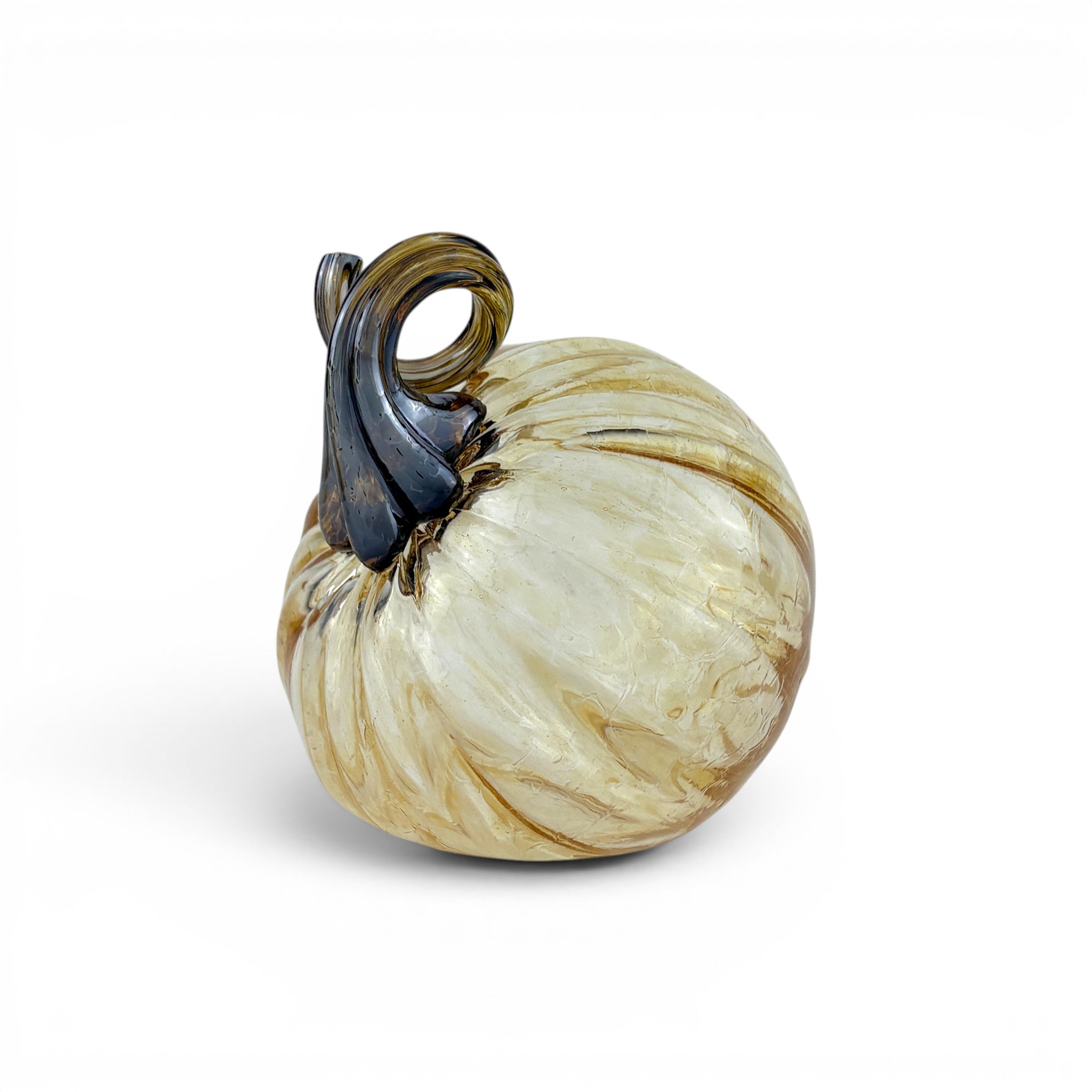 A decorative glass pumpkin with a cream and gold marbled body and a dark brown stem.