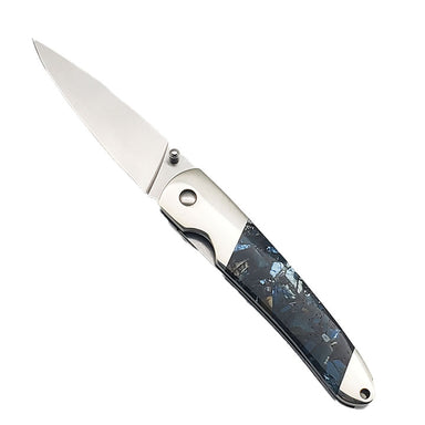 A knife with a stainless steel frame and blade, featuring a handle with mammoth tusk fragments in a blue composite material.