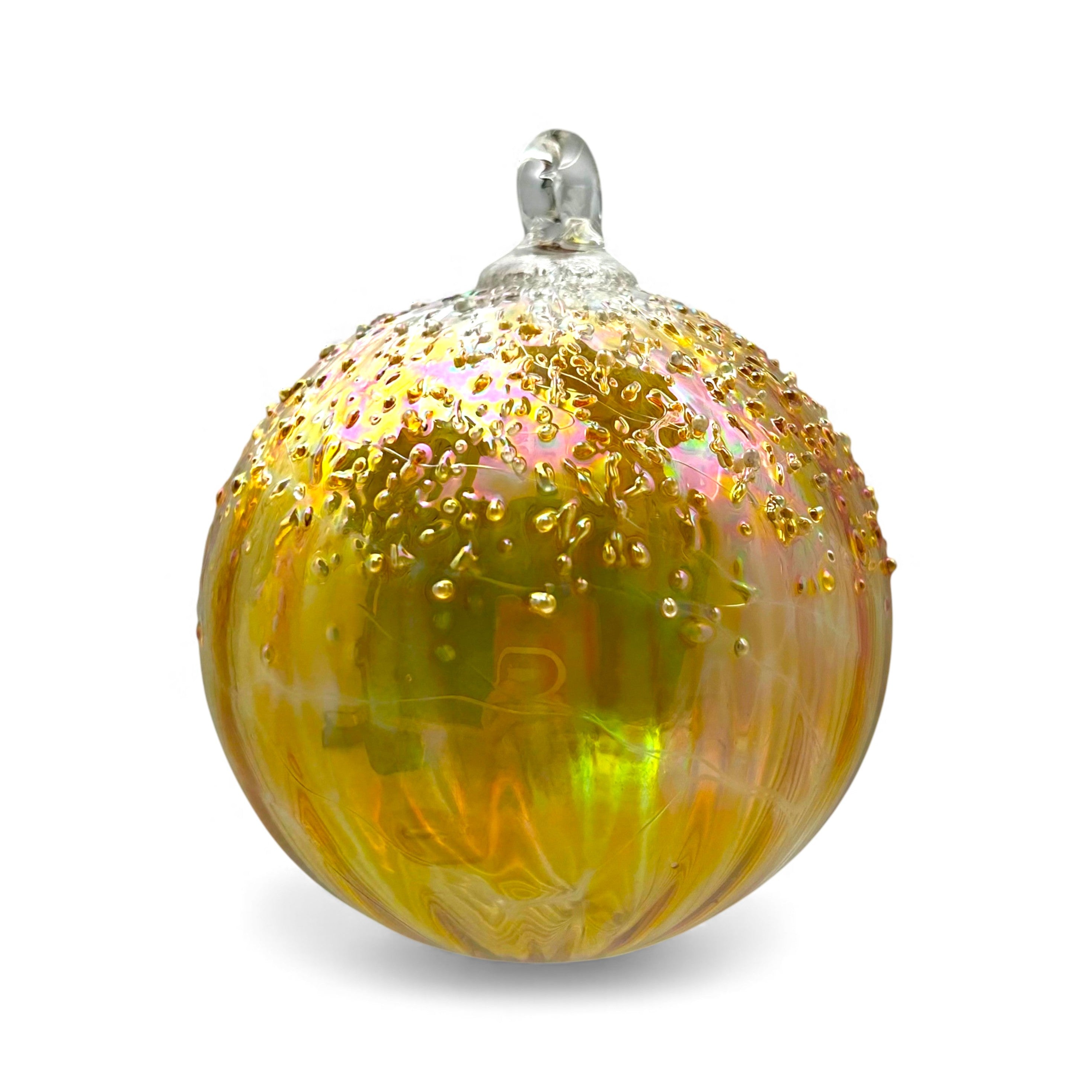 Decorative glass ornament with gold and pink speckles on a white background