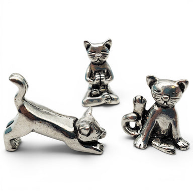 Three silver cat charms on a white background