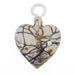 A heart-shaped glass ornament with a floral pattern, primarily in white and green colors, with a loop for hanging.