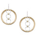 A pair of earrings featuring a wide brass ring with three smaller silver rings suspended in the center, hanging from silver ear wires.