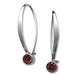 A pair of handcrafted, slender silver earrings with garnet gemstone accents.